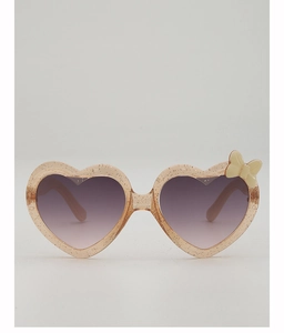 Détail de lunettes de soleil enfant cœur rose avec paillettes et décoration nœud