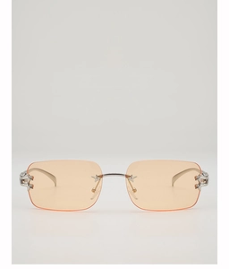 Detail of star-shaped metal accents on rimless Y2K square sunglasses with orange lenses