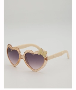 Détail de lunettes de soleil coeur pour enfants avec monture pailletée rose et nœud