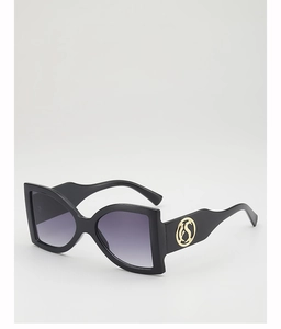 Detail view of large butterfly sunglasses with purple gradient lenses and gold S logo