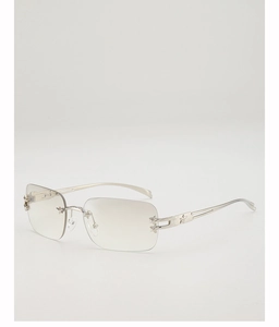 Detail of star-shaped metal accents on rimless Y2K sunglasses with silver temples