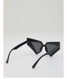 Detail view of bold geometric black sunglasses with thick cat-eye frames and polished finish