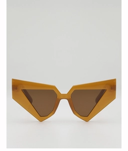 Close-up of amber cat-eye sunglasses featuring a geometric triangular frame design