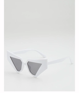 Detail view of bold white oversized sunglasses with gray triangular lenses and punk aesthetic