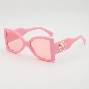 Pink oversized sunglasses with gold S-logo temple and UV protection lens on white background
