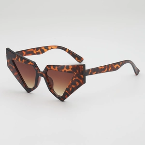 Chic geometric tortoise shell sunglasses with dark brown gradient lenses in a studio shot