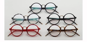 Detail view of five assorted round vintage eyeglasses with tricolor temple tips