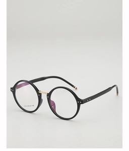 Detail of round black frame glasses with iconic tricolor stripes on temple tips