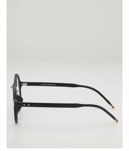 Detailed side view of black round glasses frame featuring classic tricolor temple tips