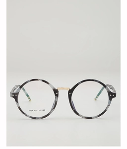Detailed close-up of retro round tortoiseshell frames with ornate gold metal bridge and hinges
