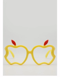 Macro detail of yellow apple-shaped decorative eyeglass frames with red leaf accents