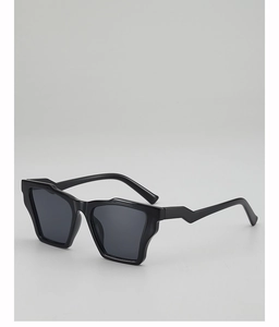 Detail of black irregular geometric resin sunglasses with curved temple and dark grey lenses