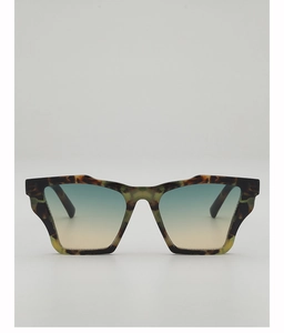 Close-up of leopard cat-eye sunglasses with gradient lenses and unique geometric wing frame