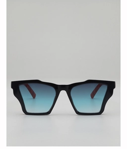 Close-up of geometric irregular sunglasses with blue gradient lenses and tortoiseshell temples