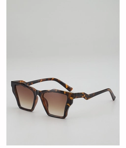 Detail view of tortoiseshell sunglasses with unique jagged temples and brown lenses