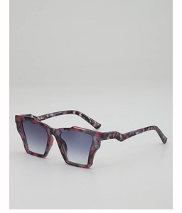 Detail of red tortoiseshell frame with blue gradient lenses and unique zigzag temples