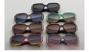 Collection of oversized square sunglasses in seven colors with gold temple accents