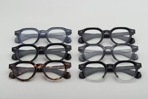 Top view of six assorted vintage round frame glasses showing different colors and textures