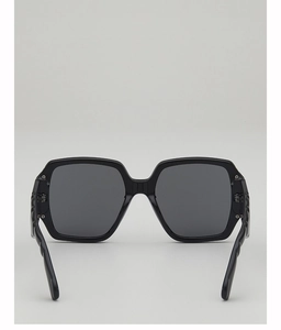 Close-up of square sunglasses with wavy textured temples and metallic rivet accents