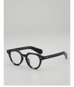 Detail shot of vintage round black glasses frame with iconic double metal rivets
