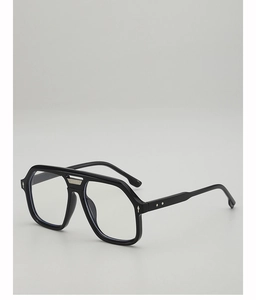 Close-up of black oversized aviator frames with silver rivets and metal double bridge bar