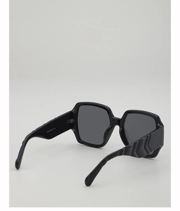 Detailed view of square sunglasses featuring bold textured temples and inner frame model text