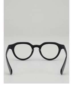 Detailed view of black thick frame glasses with glossy finish and sturdy wide temples