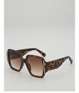 Detail of square oversized tortoiseshell sunglasses with textured wide temples and metal trim