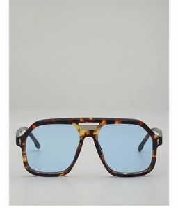 Detail of tortoise frame sunglasses with blue lenses and silver arrow hinge accents
