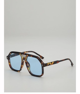 Detail of dark tortoise aviator frames with vintage double bridge and light blue lenses