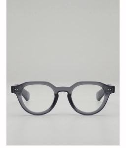 Detail of translucent gray thick frame glasses with visible metal hinge rivets on temples