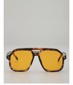 Detailed close-up of tortoise shell aviator frame with yellow lenses and metal double bridge