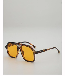 Close-up of tortoise aviator sunglasses with yellow lenses and metallic bridge detail