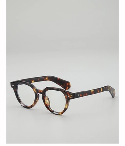 Detail shot of vintage tortoise shell eyeglass frames with silver metal rivets on the side