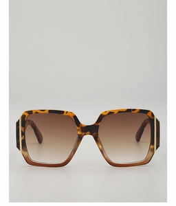 Detailed view of tortoiseshell frame sunglasses with gold metal hinges and gradient lenses