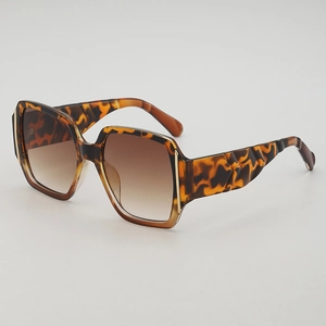 Square tortoise shell sunglasses with gradient brown lenses and wavy gold detail temples