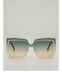 Detail of oversized square sunglasses with gradient lenses and gold H-shape hinge accents