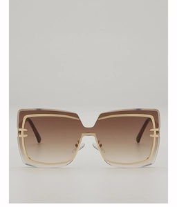 Detail of oversized square sunglasses featuring gradient brown lenses and golden metal accents