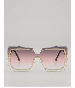 Close-up of oversized square sunglasses with purple gradient lenses and gold metal trim