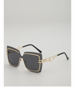Detail of oversized square sunglasses with gold metal frame and geometric hollow temple