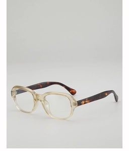 Gros plan de lunettes rétro avec monture en résine jaune et branches en écaille