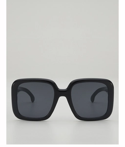 Detailed front view of oversized square sunglasses with black frames and dark grey lenses