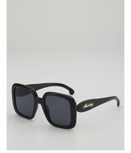 Detail of glossy black square frame sunglasses with golden Marchery brand lettering