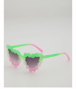 Detail of heart-shaped kids sunglasses with floral relief and green-pink gradient finish