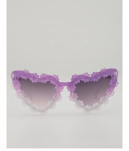 Detail of heart-shaped kids sunglasses with purple gradient frame and 3D floral accents