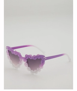Detail view of heart-shaped purple sunglasses with multi-colored 3D floral decorations