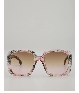 Detailed macro view of square floral frames and gradient lenses of these chic sunglasses