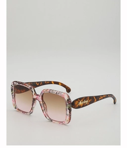 Close-up of oversized square sunglasses with floral frame and tortoiseshell temples