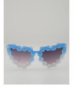 Detail of heart-shaped kids sunglasses with blue floral frame and gradient lenses