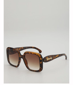 Detail of tortoise shell square sunglasses with brown gradient lenses and gold logo